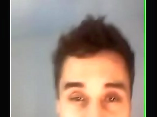 brazilian shemale laying on white bed sheet plays with cock